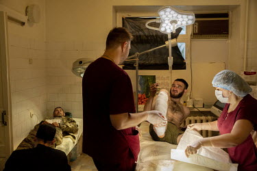 Andriyn Kalinovskiy (26), nicknamed Kalina, in the operating theatre at a military hospital in an undisclosed location close to the frontline. He has just had a lot of shrapnel removed from his leg bu...