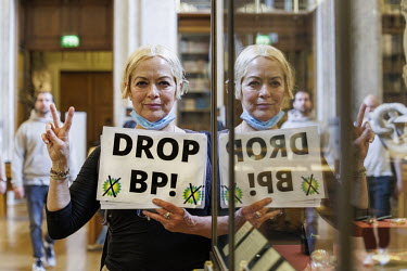 A woman holds a 'Drop BP!' sign at the British Museum where climate activist group 'BP or not BP' staged a 'Drop BP' event, calling for an end to BP sponsorship.