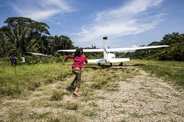 A child chases a light aeroplane along a dirt runway that allows small planes to land for health reasons or for visits by political or administrative personalities.  The Kichwa people of Sarrayku refu...