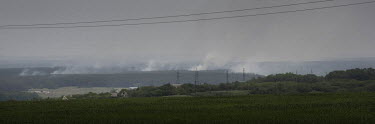 Smoke rises from heavy fighting around Lyman as Russian forces try to encircle Severodonetsk and Lysychanksk. Seen from the hillside village of Malaky, on the Siverskyi Donets River. A frontline villa...