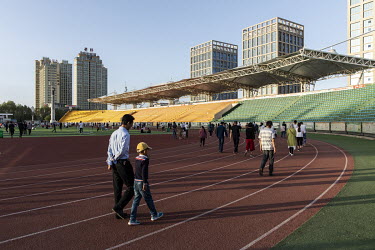 People relaxing and enjoying themselves in a sports stadium that is open to the public.