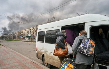 People squeeze onto evacuation transport to leave the city using a minibus organised by volunteers from SOS Vostok.