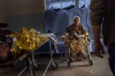 Andre sits in a wheelchair waiting for further examinations and treatment at a military hospital in an undisclosed location close to the frontline. He was injured by shrapnel fragments in his torso bu...