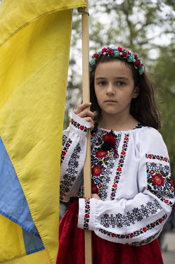 Alina (8) holds an Ukrainian flag at a protest, in front of Downing Street, by Ukrainians against Russia's invasion of their homeland.