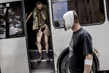 Wounded soldiers alight from a bus that has brought them from various locations to a military hospital close to the frontline in an undisclosed location in Donetsk. Most have been wounded by Russian a...