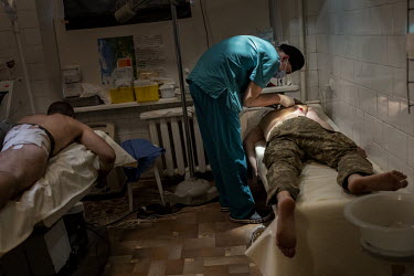 Medical staff remove shrapnel from the bodies of two soldiers wounded during fighting outside of Bakhmut and towards Luhansk. Soldiers at this hospital have come from various medical facilities where...