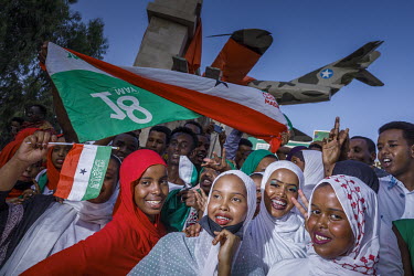 People gather beneath an inflatable MIG fighter plane which forms part of the 31st independence day celebrations. During the late 1980s it was this type of aeroplane that completely destroyed Hargeisa...