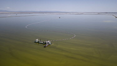 A barge pumps brine from an evaporation pond operated by Qinghai Salt Lake Industry Co. in the Chaerhan Salt Lake. Qinghai Salt Lake produces potash fertilisers, potassium chloride and lithium carbona...