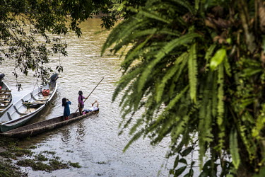 Children play in a canoe on the Rio Bobonaza. The river is the main link between the people of Sararyaku and the world outside of the forest. It takes four hours by motor canoe to reach the heart of t...