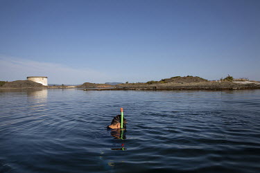 A secondary school pupil snorkelling in a lake during one of their weekly excursions.