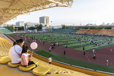 People relaxing and enjoying themselves in a sports stadium that is open to the public.