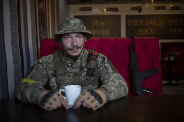 Soldier Nikita Rozhenko (29), drinking coffee in a cafe in Lozova. He says he was a pro-Russian counsellor before the war started but now he has resigned from his party and joined up to serve in the U...