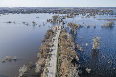 A road connecting Demydiv and nearby Kozarovychi is one of the only roads in the area not underwater. The cause of the current flooding is not clear with speculation that it was either an Ukrainian at...