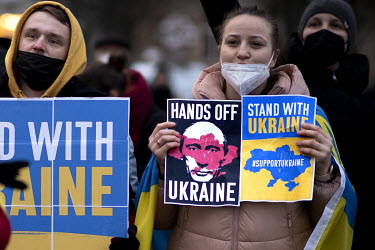 Ukrainian activists in front of the Chancellor's office holding signs supporting Ukraine and against President Vladimir Putin following the Russian military invasion of Ukraine.