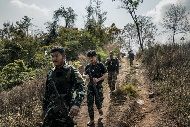 Min Thar (2nd from left), a former banquets and events worker at the Lotte Hotel in Yangon who joined the People's Defence Force (PDF), patrols with other PDF soldiers on the frontline close to Myanma...