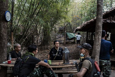 Naw Htee Mupaw, a sergeant in the KNPF Karen ethnic armed group sits with other soldiers from DKBF ethnic armed group and the People's Defence Force (PDF) on a PDF base in an undisclosed location in K...