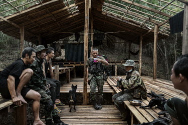 Soldiers from the DKBF ethnic armed group and People's Defence Force (PDF) gather at a shelter in a PDF camp in an undisclosed location in Karen State.
