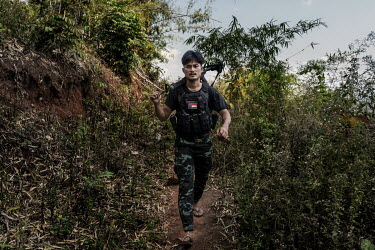 Min Thar, a former banquets and events worker at the Lotte Hotel in Yangon who joined the People's Defence Force (PDF), patrols with other PDF soldiers on the frontline close to Myanmar Army positions...