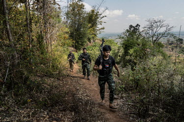 Min Thar (front), a former banquets and events worker at the Lotte Hotel in Yangon who joined the People's Defence Force (PDF), patrols with other PDF soldiers on the frontline close to Myanmar Army p...