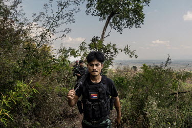 Min Thar (front), a former banquets and events worker at the Lotte Hotel in Yangon who joined the People's Defence Force (PDF), patrols with other PDF soldiers on the frontline close to Myanmar Army p...
