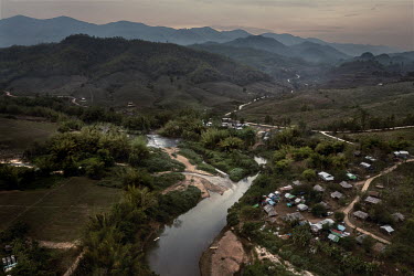 The Moei River that separates Thailand, bottom left, from Myanmar (top and right) where a Karen IDP camp for people displaced by Myanmar Army attacks on Lay Kay Kaw can be seen, bottom right, and jung...
