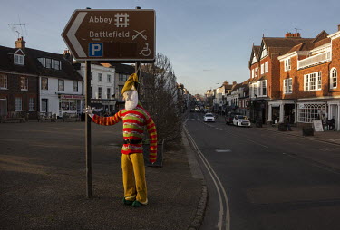 A knitted Father Christmas (Santa Claus) figure points the way to the Abbey and 1066 Hasting battlefield site in the town of Battle.