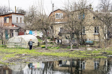 A local resident of Demydiv, looks at the floodwaters which ruined her home but which are now starting to recede. The cause of the current flooding is not clear with speculation that it was either an...