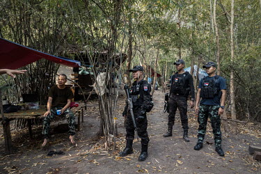 Arkar (right), a former chef at the Novotel Hotel in Yangon and now a People's Defence Force soldier, listens to a briefing before an operation with other PDF soldiers (left) and fighters from the DKB...