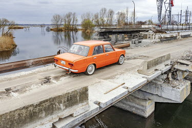 A vehicle passes over the destroyed Irpin dam and lock on the Kyiv reservoir which used to pump water from the low-lying Irpin to the level of the Dnipro-fed Kyiv reservoir. The cause of the current f...