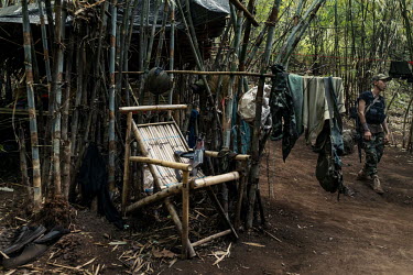 A soldier from the KNLA, a Karen ethnic armed group, walks through a joint KNLA and People's Defense Force (PDF) base in an undisclosed location in Karen State.