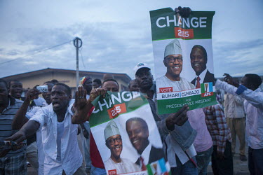 Men celebrate as Muhammed Buhari wins the presidential election.