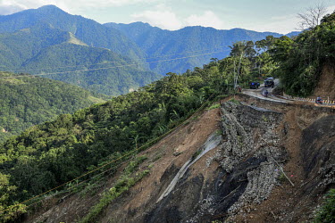 A sign warned drivers to be cautious on a stretch of road which has partly collapsed due to a landslide.