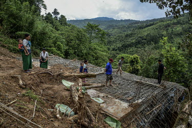The parents and relatives of Nchilungle Jeme (10) mourn at the place in Hoki Puonci village where their house once stood until it was destroyed by the landslide which took the life of their daughter.