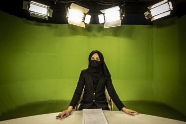 TV reporter Sohaila Yousofi, who works for 1TV, in front of a studio's green screen..