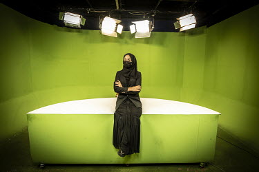 TV reporter Sohaila Yousofi, who works for 1TV, in front of a studio's green screen..