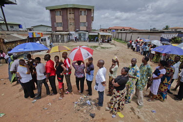 Nigeria goes out to vote for the presidential election. The turn out is high with long queues at many of the polling stations. Voters wait patiently to cast their votes.