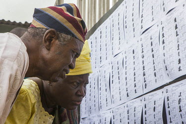 Voters checking their names on the registered voters list in Lagos.