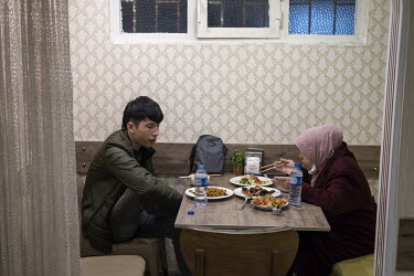 An Uyghur man and woman eating a meal after taking part in a demonstration in front of the Chinese embassy in Istanbul protesting human rights abuses against Uyghurs in Xinjiang.