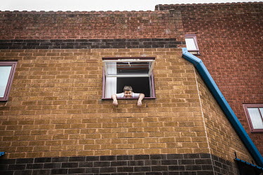 Junior Tams (9) looks out from his home on the Byker Estate. His mother says that since the COVID-19 lockdown began, Junior's education has worryingly regressed. Like so many others he shuts himself i...