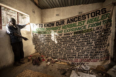 Dr Mubita, a 'Witch Doctor' and traditional healer, holds up a banner advertising his expertise. He is often consulted on medical matters including schistosomiasis (bilharzia).Female Genital Schistoso...