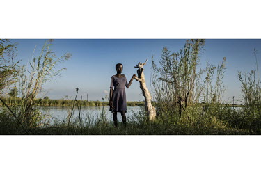 Prisca (13) on the banks of the Zambezi River which contains the parasite causing schistosomiasis (bilharzia).Female Genital Schistosomiasis (FGS) is a waterborne parasitic disease affecting women. Sy...