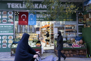 The Kokbayraq (sky flag) and a Turkish flag hang outside an Uyghur supermarket in Zeytinburnu.