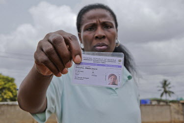 Oleka, 48, hows her voter's registration card. She is one of the many Nigerians that was barred from voting in the recent presidential election because their names were ommitted from the Independent E...