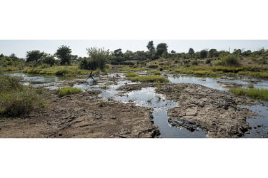 A boy crosses the Maramba River which contains the parasite that causes Schistosomiasis (Bilharzia).  Female Genital Schistosomiasis (FGS) is a waterborne parasitic disease affecting women. Symptoms i...
