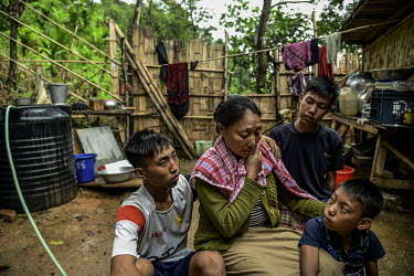 A family mourn Pauramsuilungbe Jeme at their house in Hokai Puonchi village. L-R: Kipeibe (son), Namreile (wife), Kiwangchangbe (son), Haingeuteung (son).