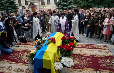 Mourners gather around the coffin containing the body of Roman Ratushny (24) outside St Michael's Monastery during his funeral. The Ukrainian serviceman and activist was killed fighting against Russia...