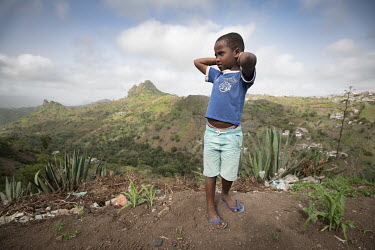 A boy stands on a hillside in Assomada, a town in Santa Catarina, an impoverished farming county an hour's drive through jagged mountains from Praia. Once, the region's main income was from beans, cor...