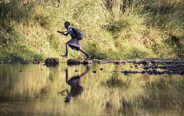 A schoolgirl crosses the Maramba River which contains the parasite causing schistosomiasis (bilharzia).Female Genital Schistosomiasis (FGS) is a waterborne parasitic disease affecting women. Symptoms...