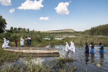 Baptists from Lusaka attend a baptism, involving full immersion in the Kafue River.  Female Genital Schistosomiasis (FGS) is a waterborne parasitic disease affecting women. Symptoms include lesions on...