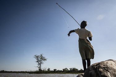 A girl fishing near the Zambezi River.  Female Genital Schistosomiasis (FGS) is a waterborne parasitic disease affecting women. Symptoms include lesions on the cervix which increase the risk of contra...